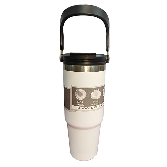 White travel mug with black handle and label on a white background