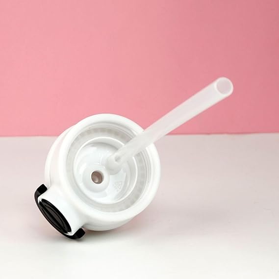 White straw lid with black rim on a pink background