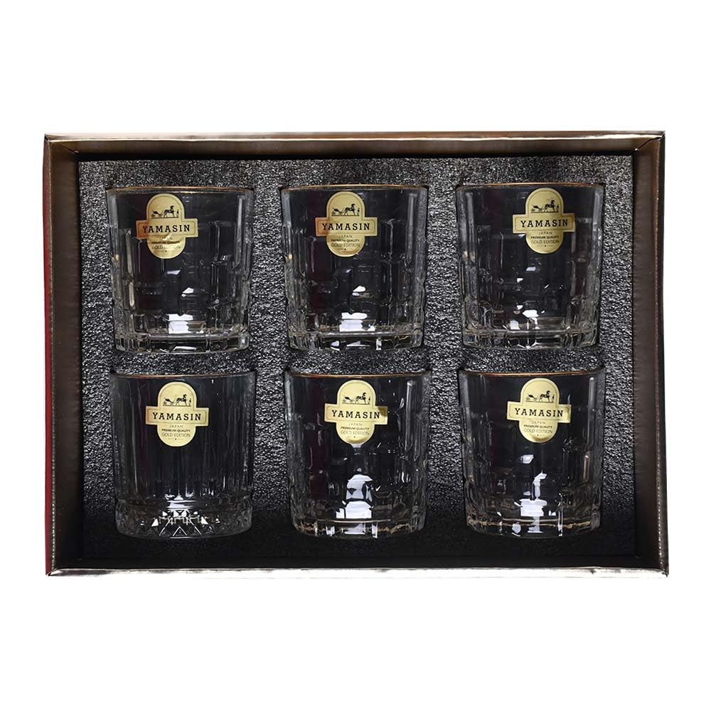 A set of six Tamashin brand clear glass tumblers with gold labels, presented in a dark gift box with a textured black insert.