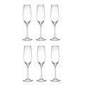 Set of six clear champagne flutes on a white background