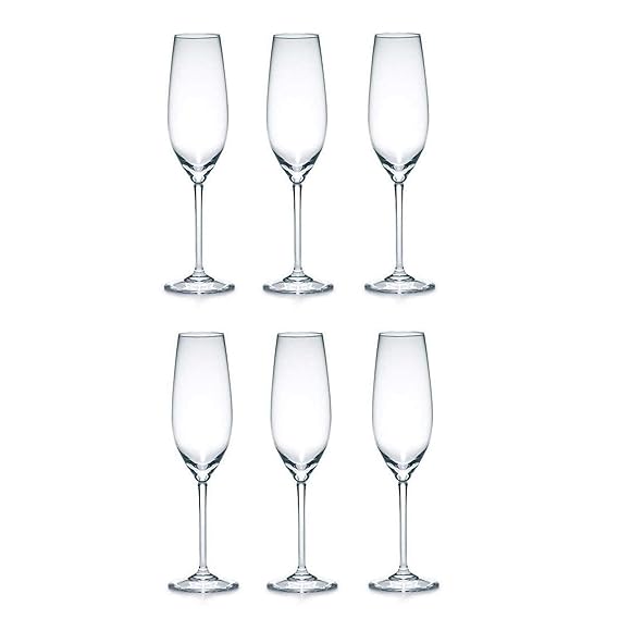 Set of six clear champagne flutes on a white background