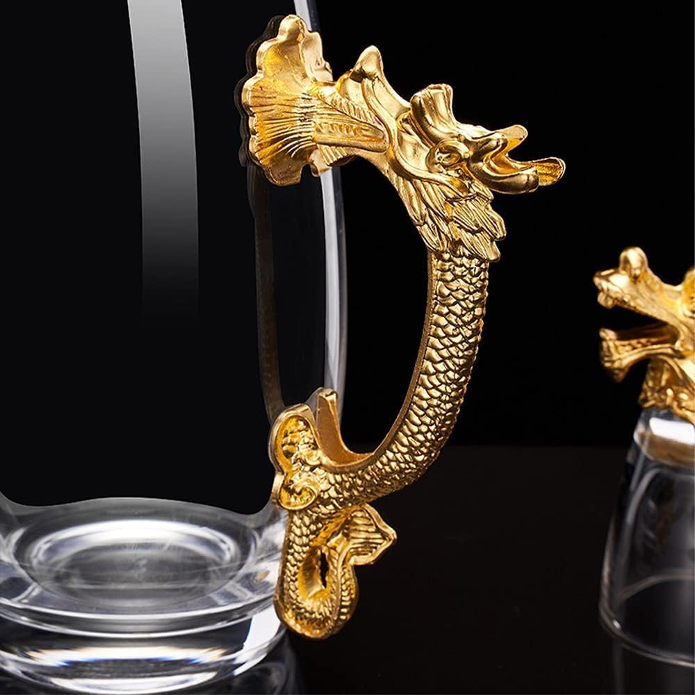 A close-up of a gold dragon-shaped glass holder or stand, shown attached to or supporting a clear drinking glass against a black background. A second similar item is partially visible on the right edge.