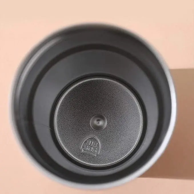 Black coffee filter with a brand logo on a beige background