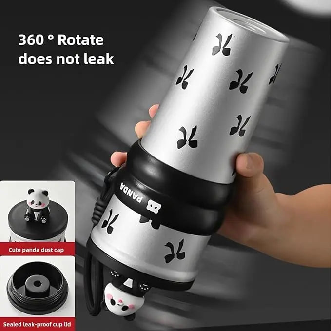 Hand holding a panda-themed water bottle with a dust cap feature, on a dark background.