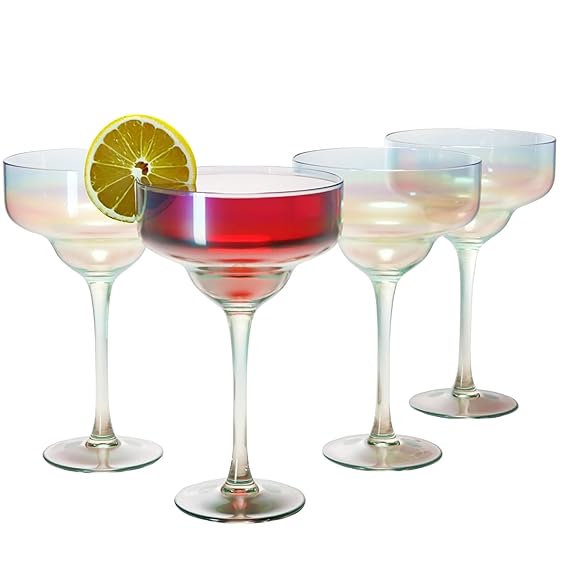 Set of four iridescent cocktail glasses with a red drink and lime wedge on a white background