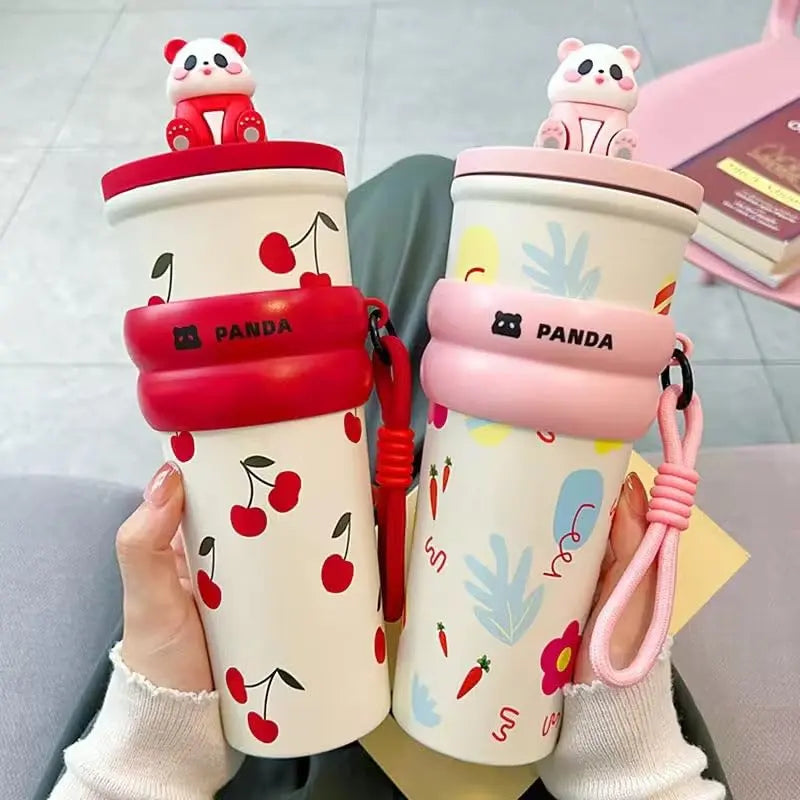 Two cartoon panda-themed cups with cherry designs on a neutral background