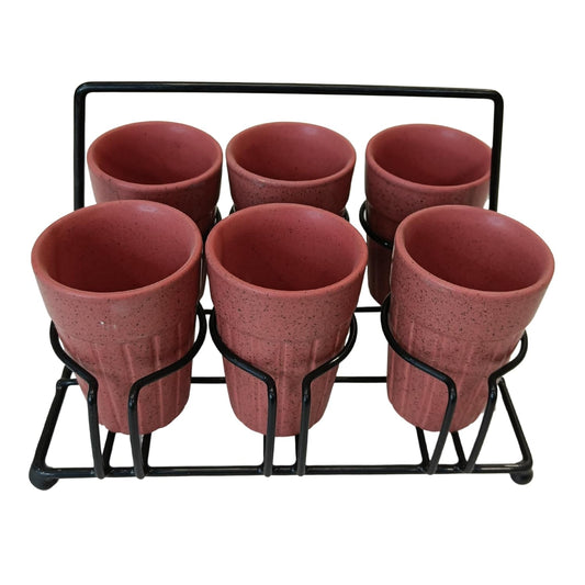 Set of six terracotta cups in a black metal stand on a white background