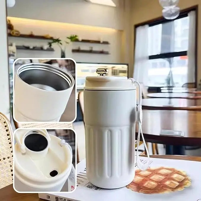 White travel mug with compartments on a table in a cafe setting