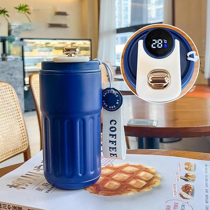Blue thermos mug with a digital thermometer on a table with waffle and coffee packaging.