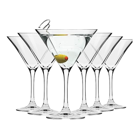 Set of six martini glasses with a lemon twist on a white background