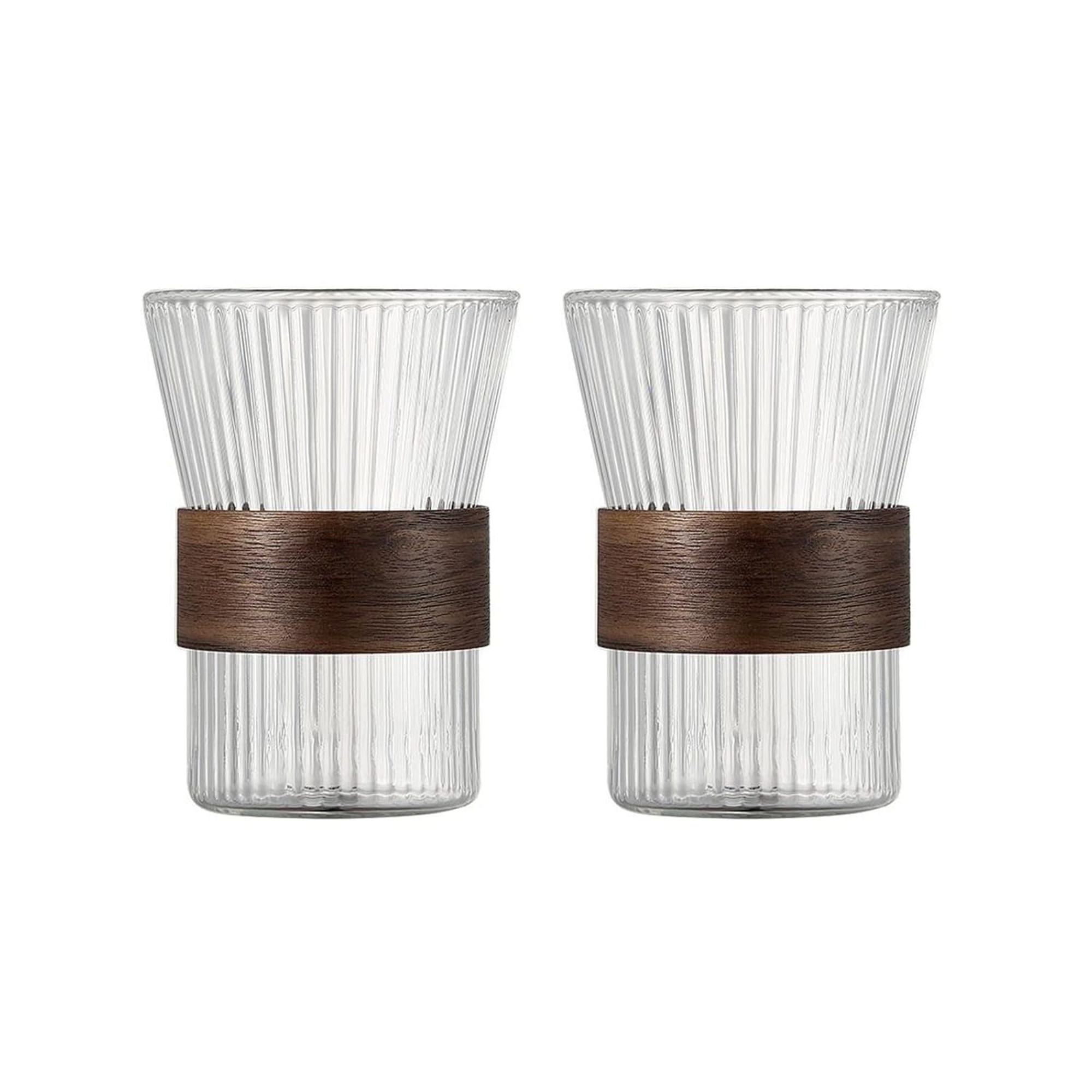 Two clear glass tumblers with brown rubber bands on a white background