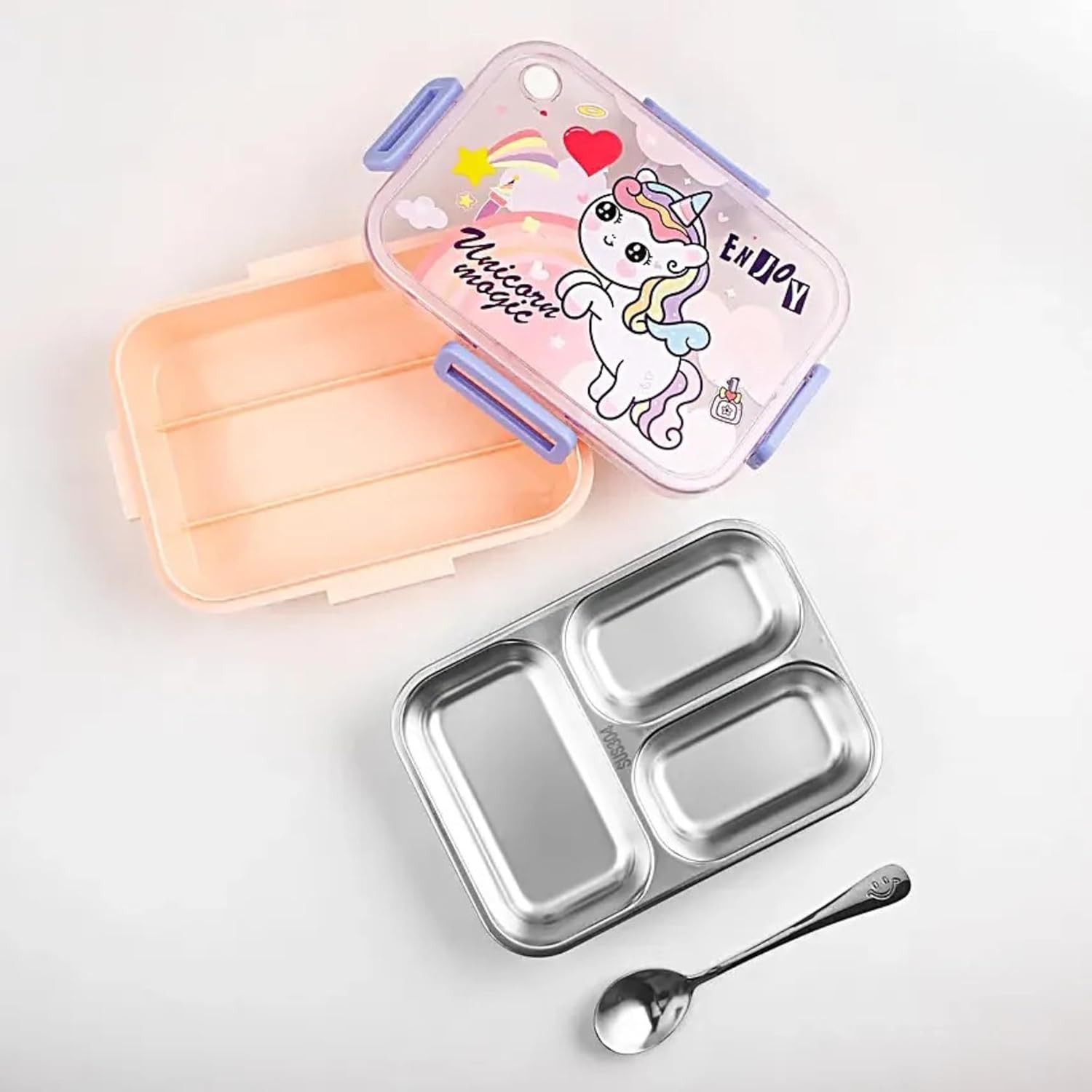 Metallic lunch box with compartments, pink lid featuring a unicorn illustration, and a spoon on a light gray background.