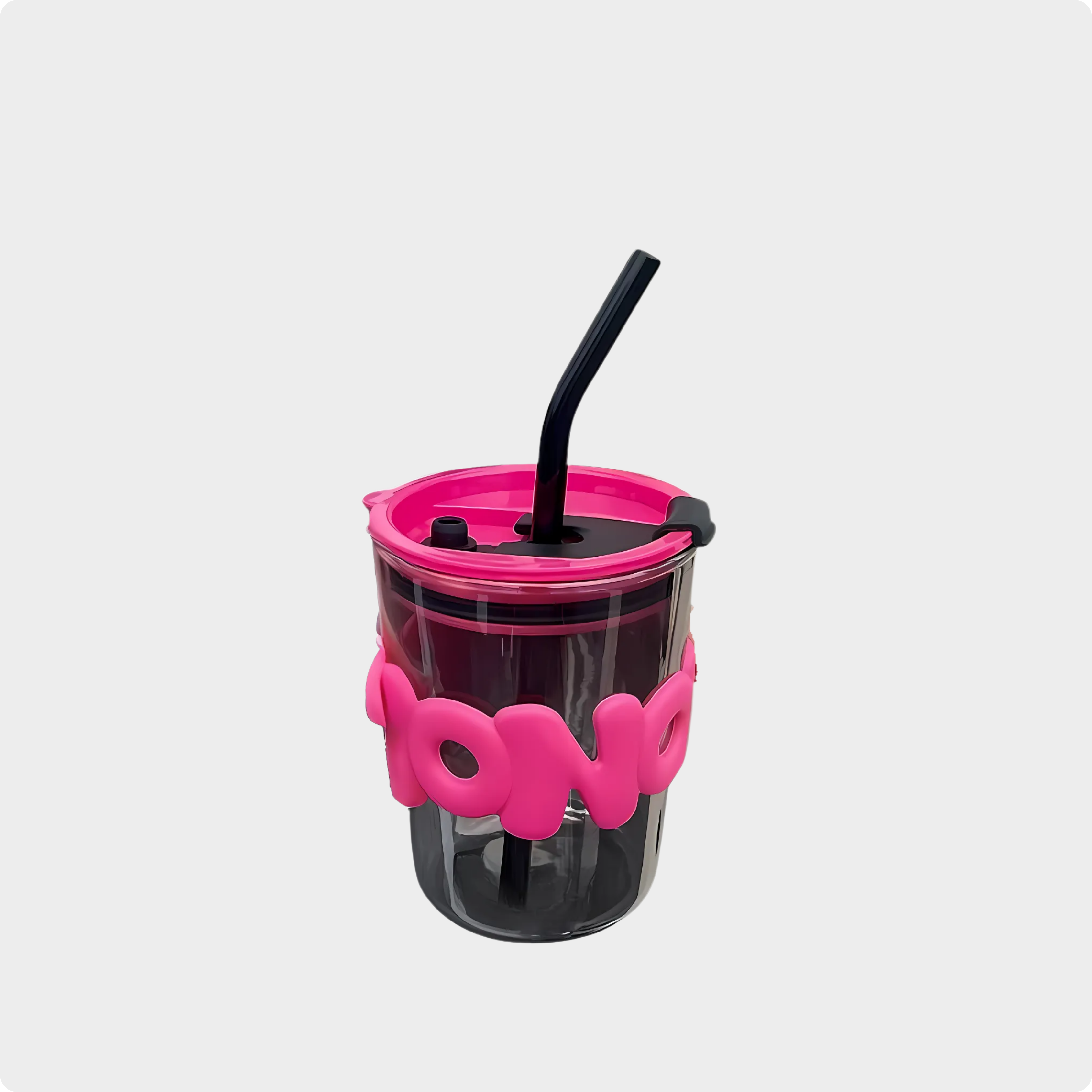 Black tumbler with pink lid and holder on a white background