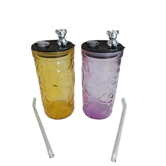 Two multicolored tumblers with black lids and straws on a white background